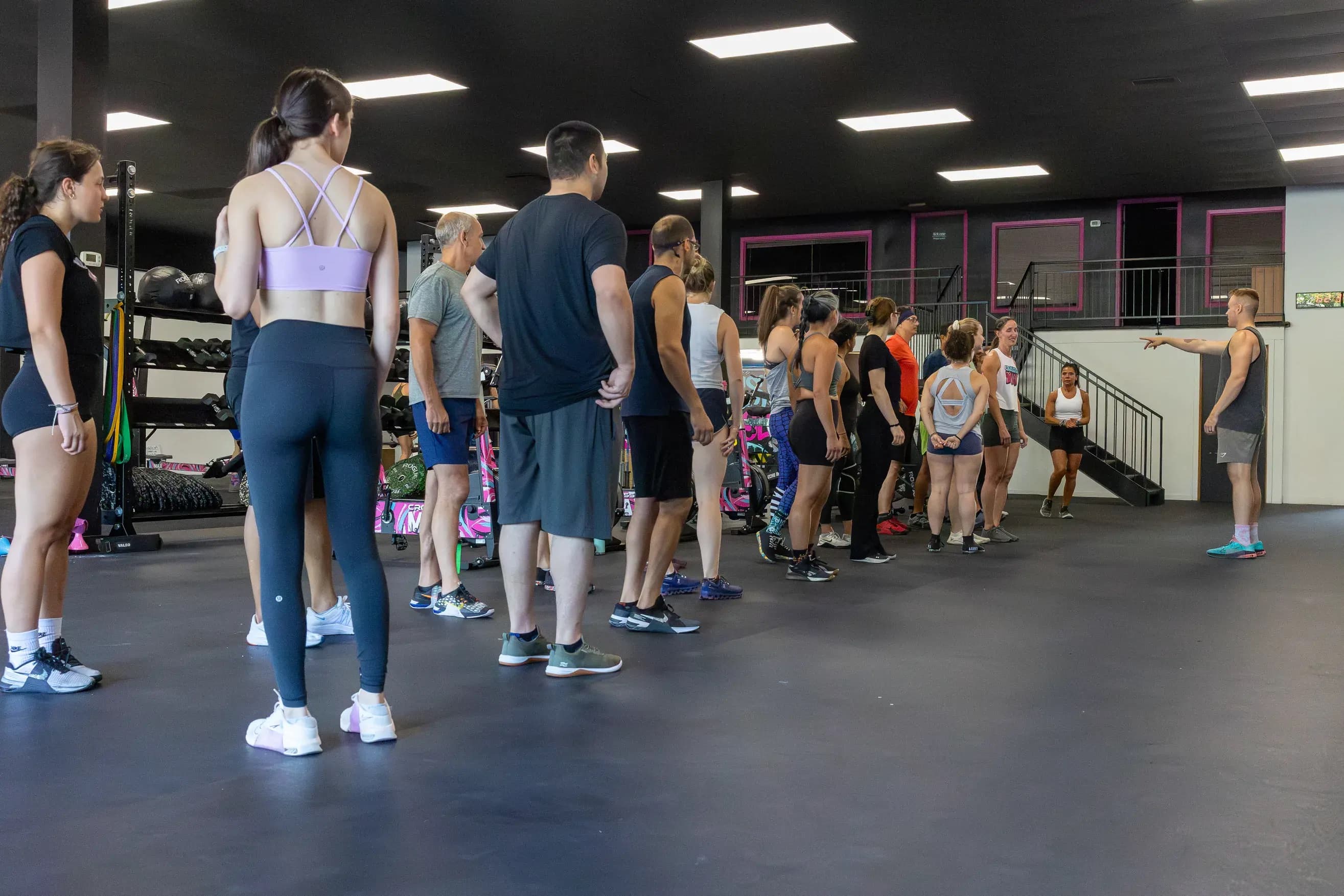A coach talks to a class before the workout.